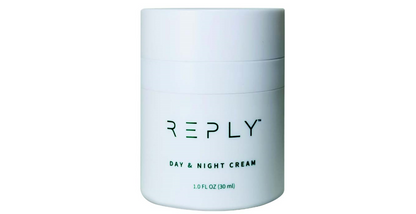 White jar of AIM REPLY Day & Night Cream on a white background