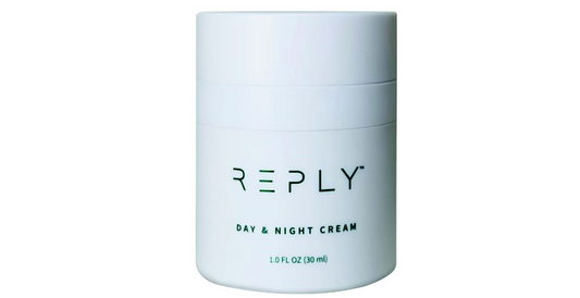 White jar of AIM REPLY Day & Night Cream on a white background
