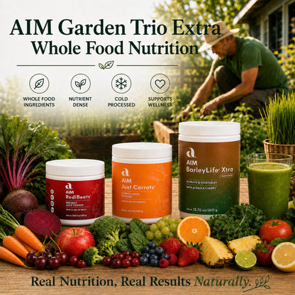 Three jars labeled AIM RediBeets, AIM Just Carrots, and AIM BarleyLife Xtra are displayed on a wooden table surrounded by fresh vegetables and fruits, with a man gardening in a sunny backyard in the background. Text overlays read 'AIM Garden Trio Extra Whole Food Nutrition' and 'Real Nutrition, Real Results Naturally.