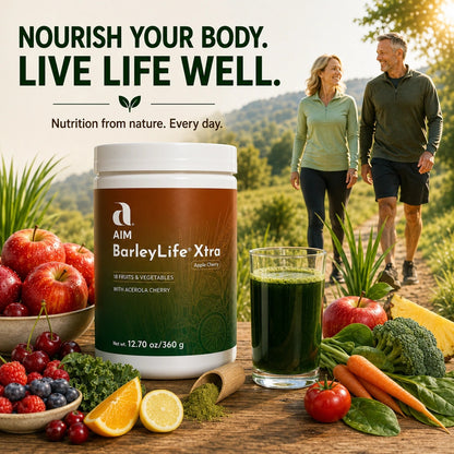 A jar of AIM BarleyLife Xtra supplement is shown in a lifestyle outdoor scene with two people walking on a trail, surrounded by fresh fruits, vegetables, and a glass of green juice. 